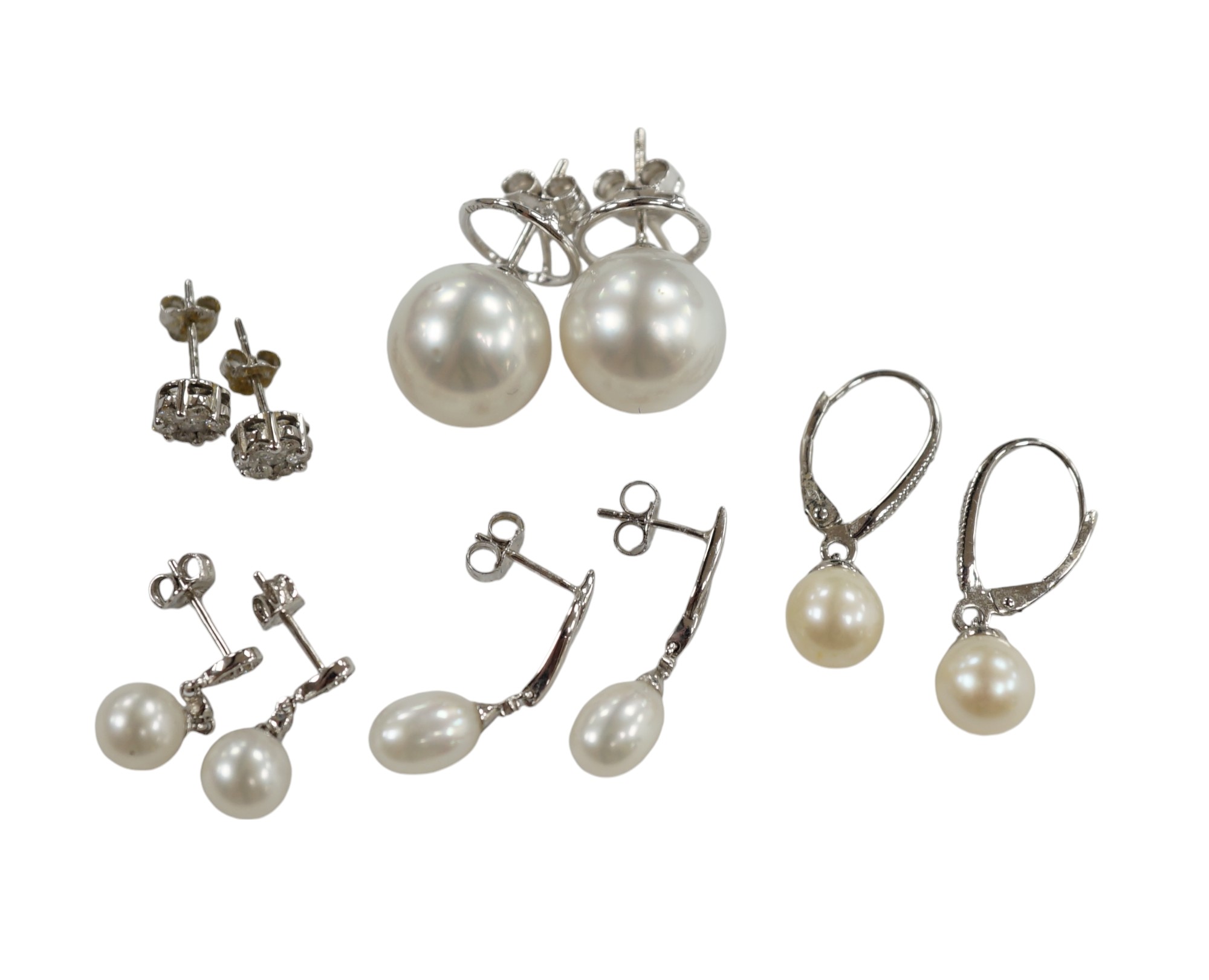 Three assorted modern pairs of 9ct, cultured pearl and diamond chip set earrings, a similar diamond cluster pair and a pair of cultured pearl earrings. Condition - fair to good